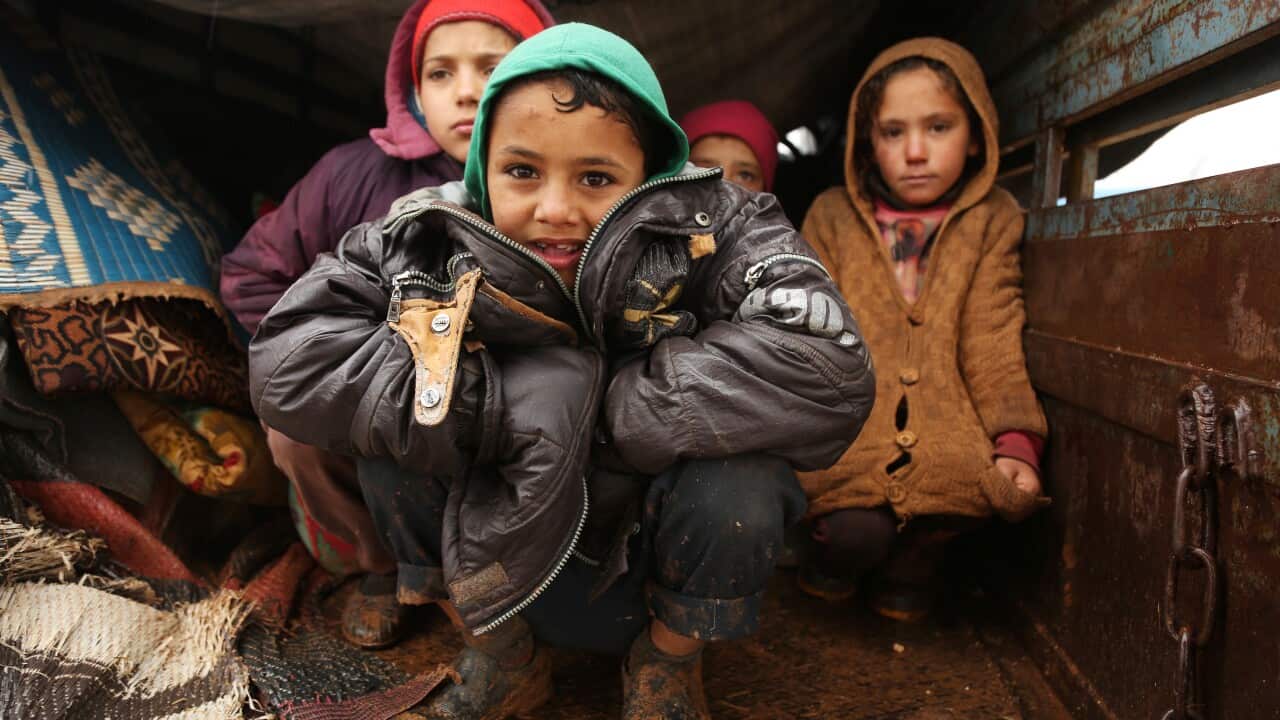 Displaced, refugee Syrian children live in a truck after fleeing violence near the Turkish border