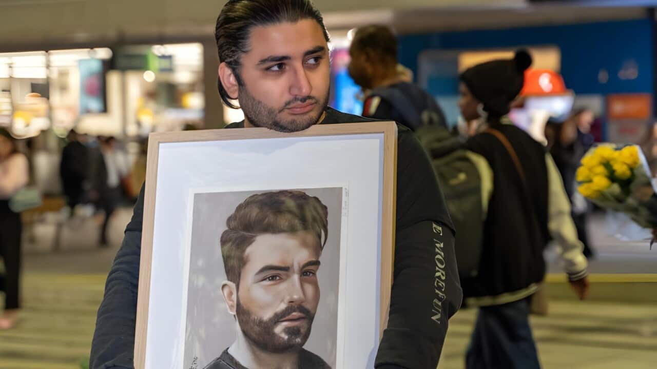 Mohammed Hashemi with a portrait of his cousin Majid Kazemi (Supplied)