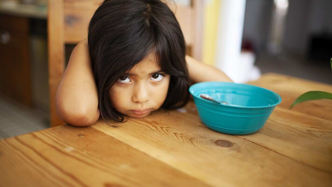 Girl Upset at Kitchen Table