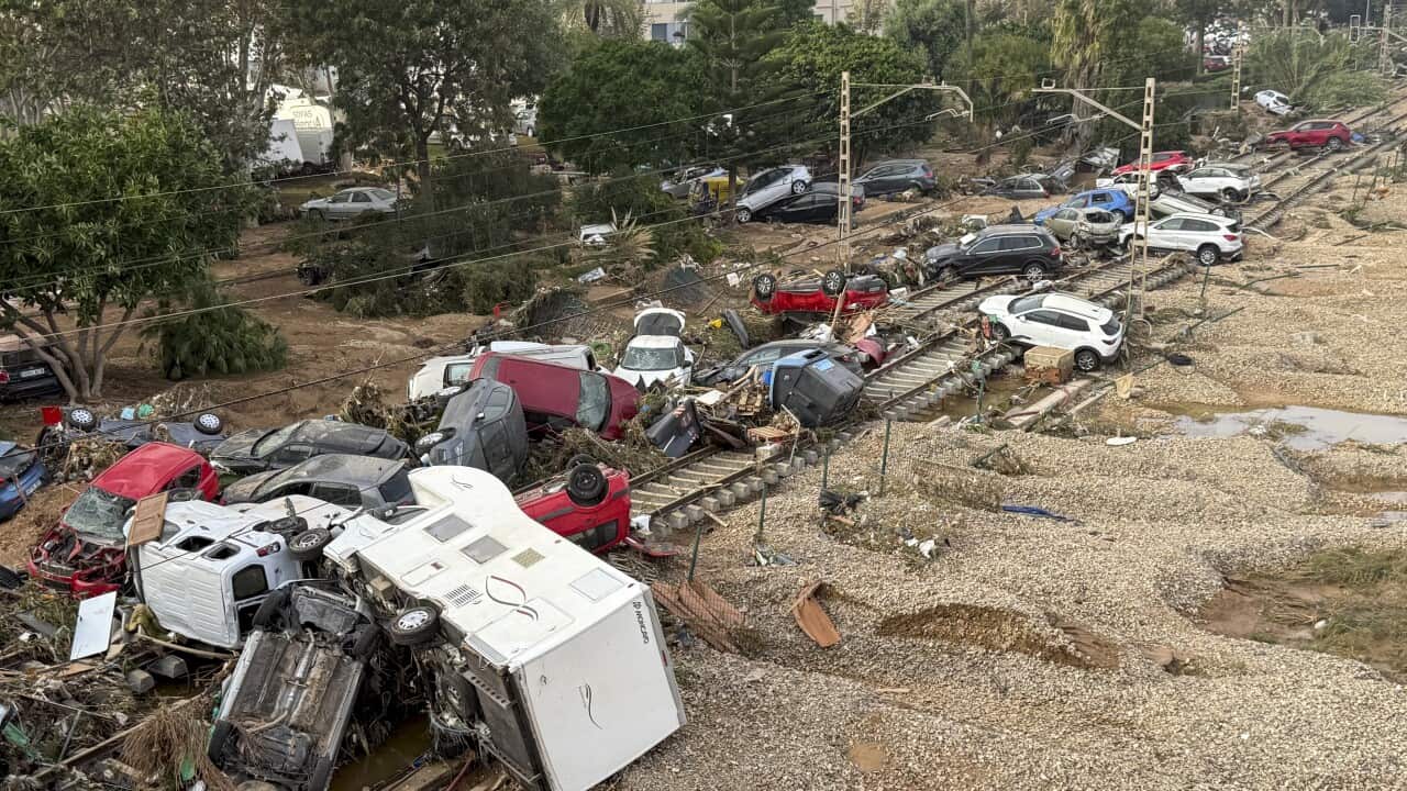 Cars and detritus cover a train track