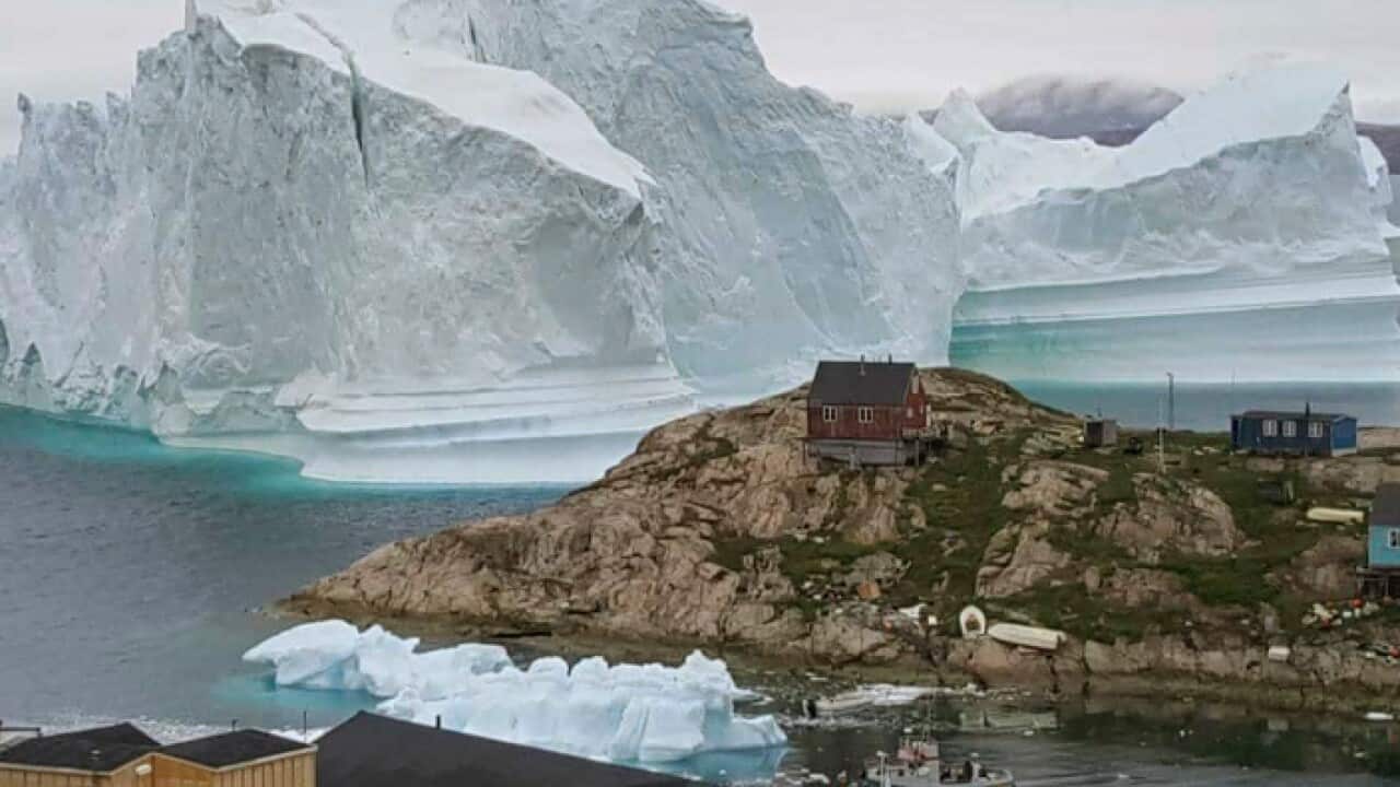An iceberg threatening the village of Innarsuit in Greenland