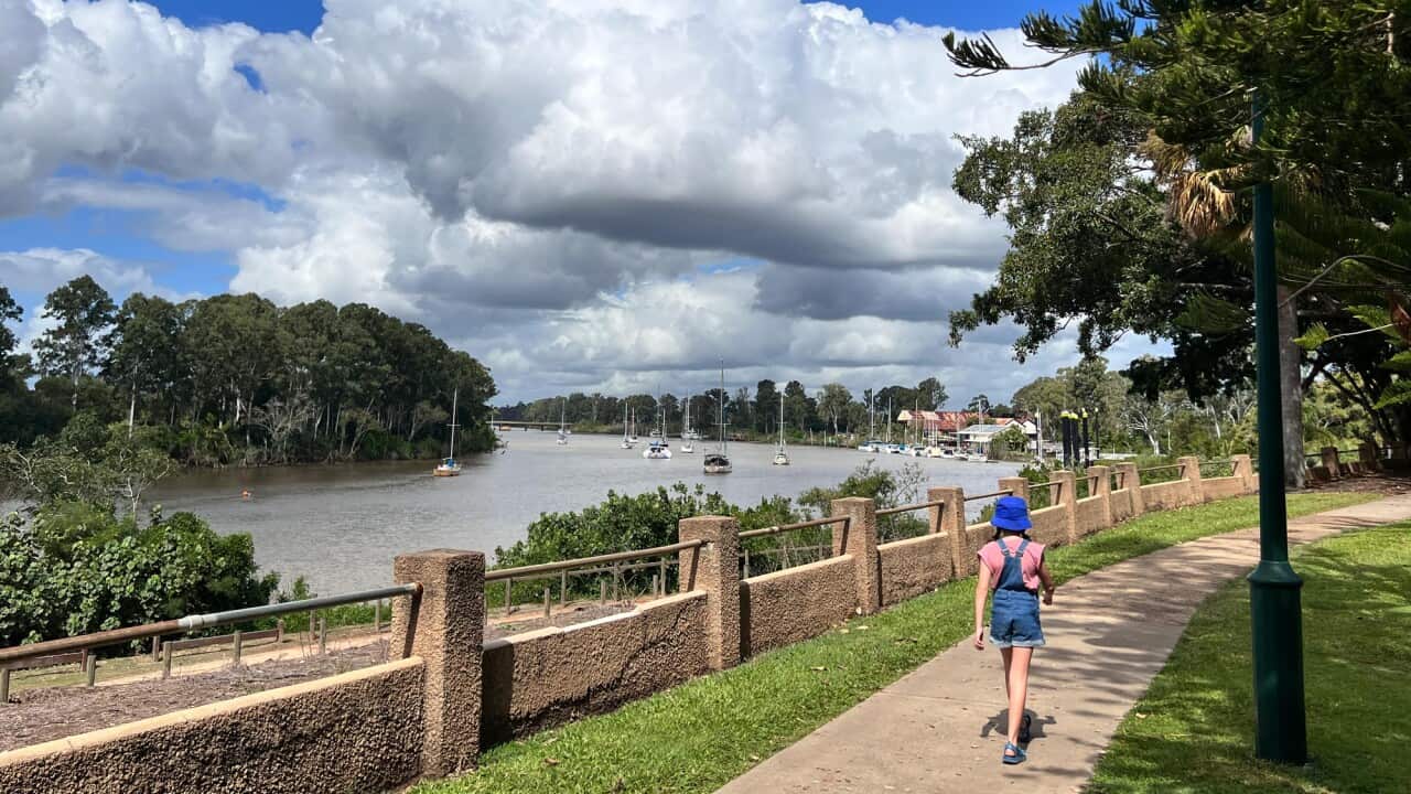 Young Australian girl walking along Mary River in Maryborough Queensland Australia