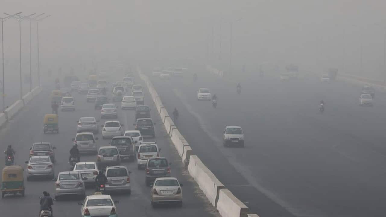 Morning traffic moves on the roads engulfed in smog, in New Delhi, India.