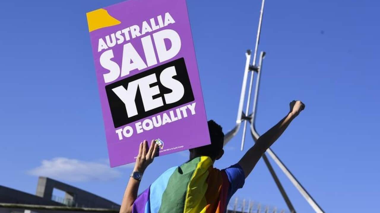 A same-sex marriage supporter outside Parliament House.