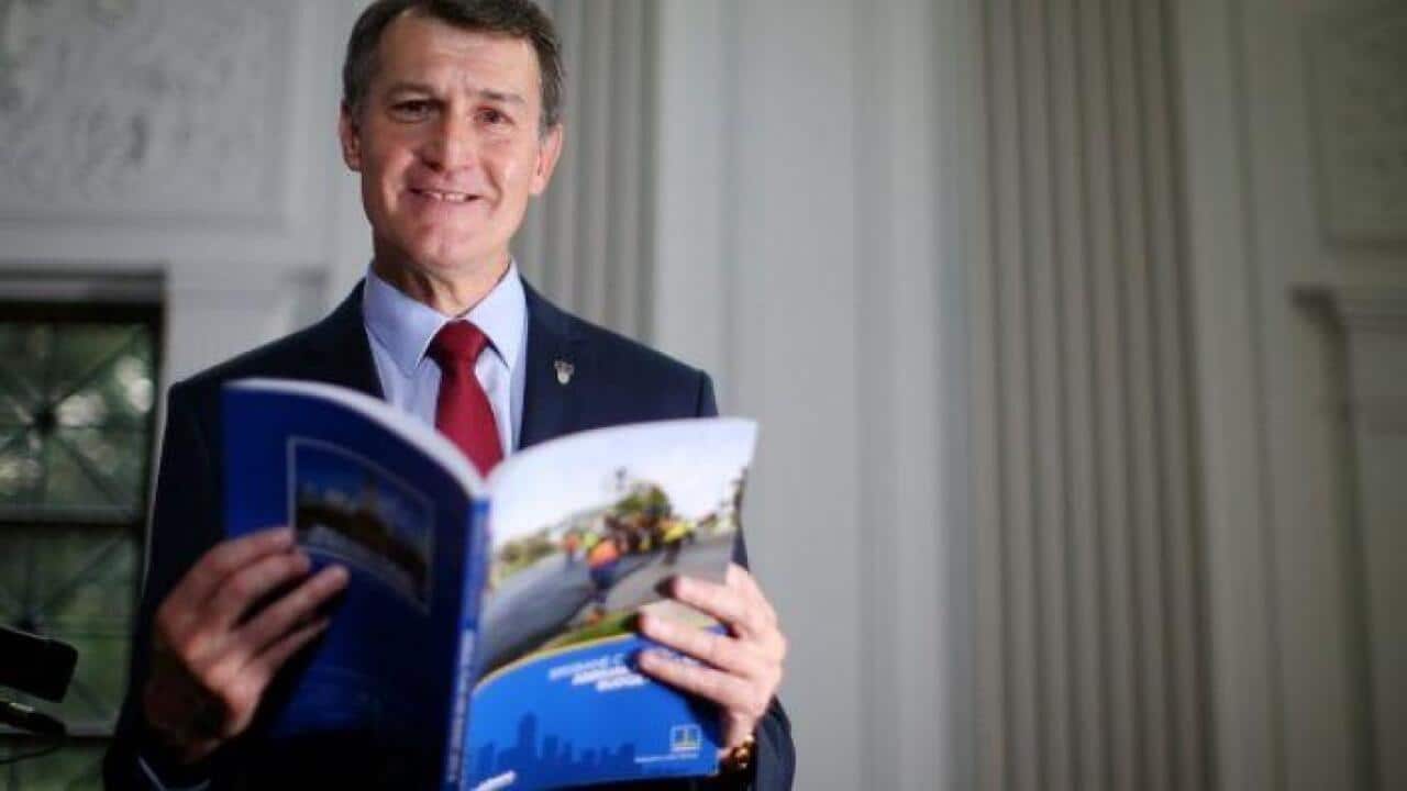Mayor Graham Quirk looks through the Brisbane City Council annual budget book at Brisbane City Hall. Photo: Chris Hyde