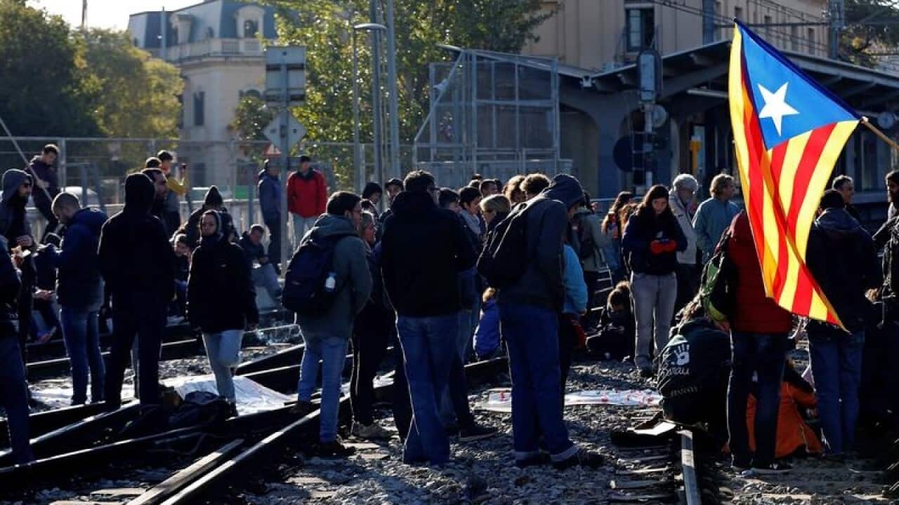 Protesters block a track in in Sant Cugat del Valles, Spain