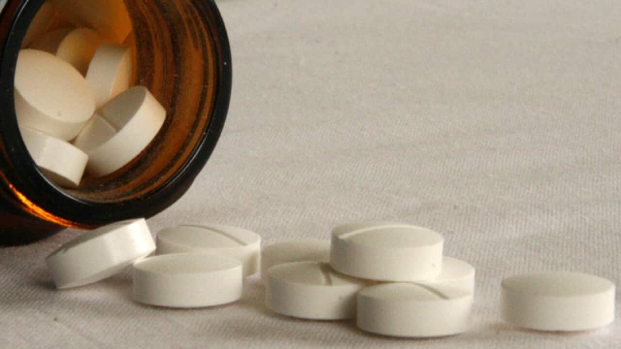 Pills fall from a bottle