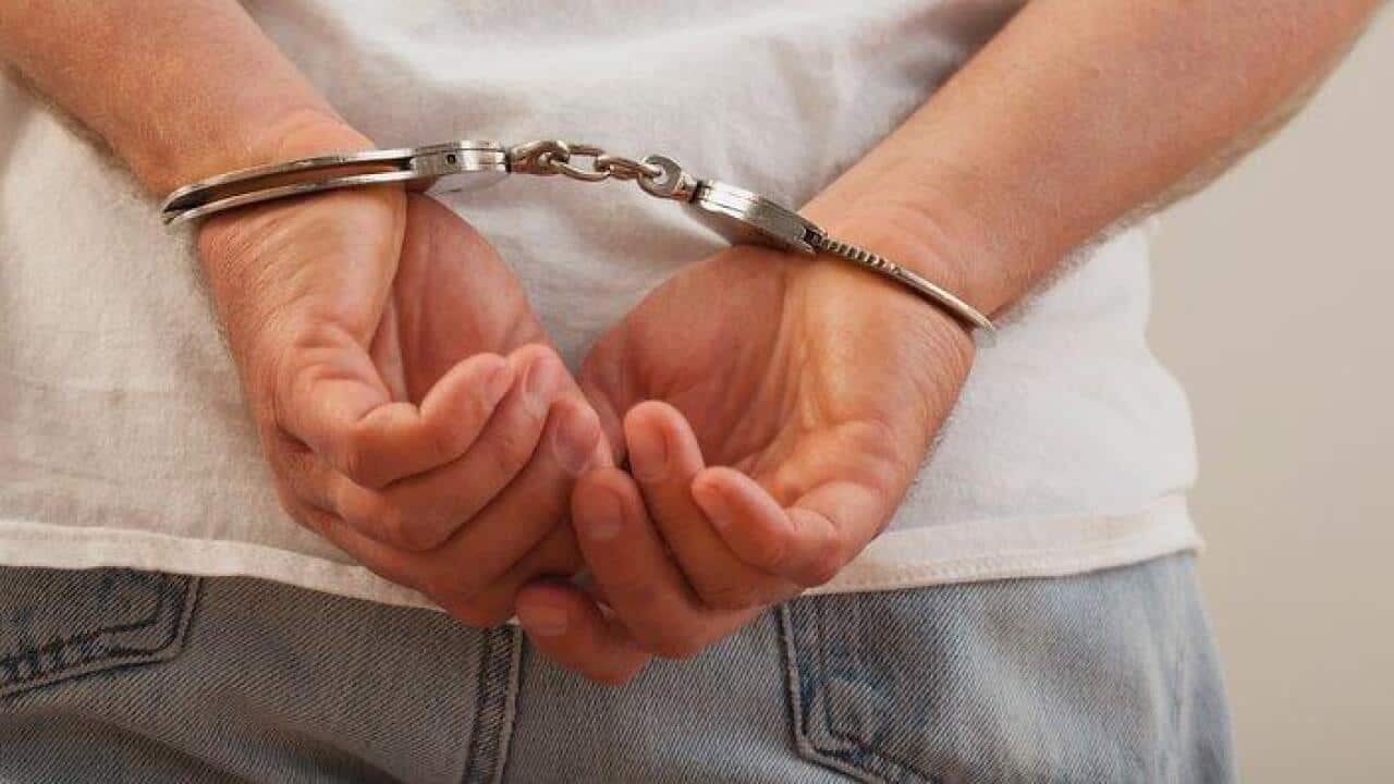 Hands in handcuffs, close-up