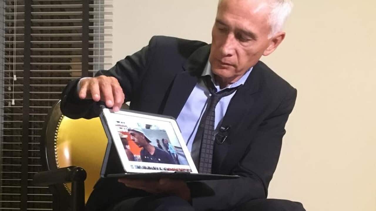 Jorge Ramos shows a video of youth picking scraps from a garbage truck