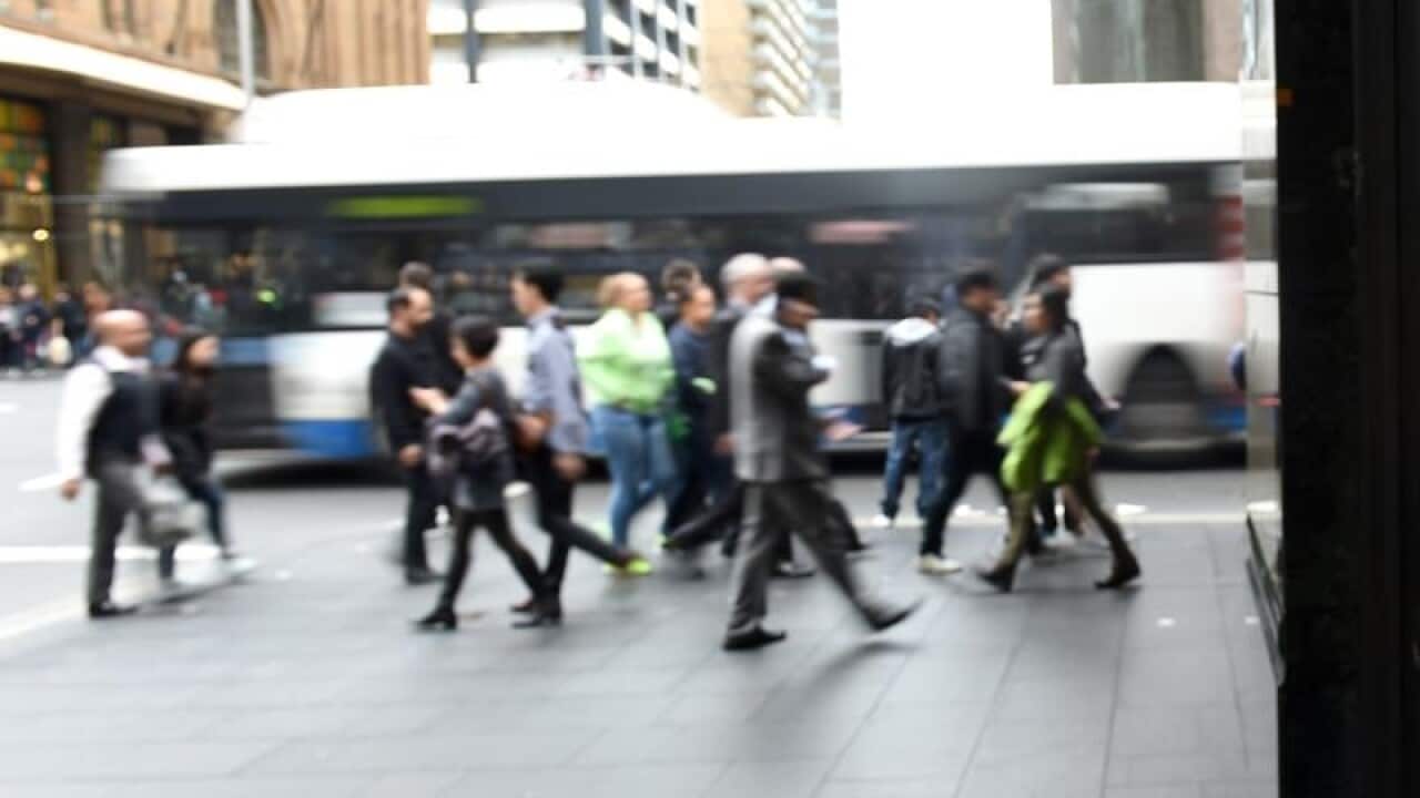 Pedestrians walk past a retail store in Sydney.