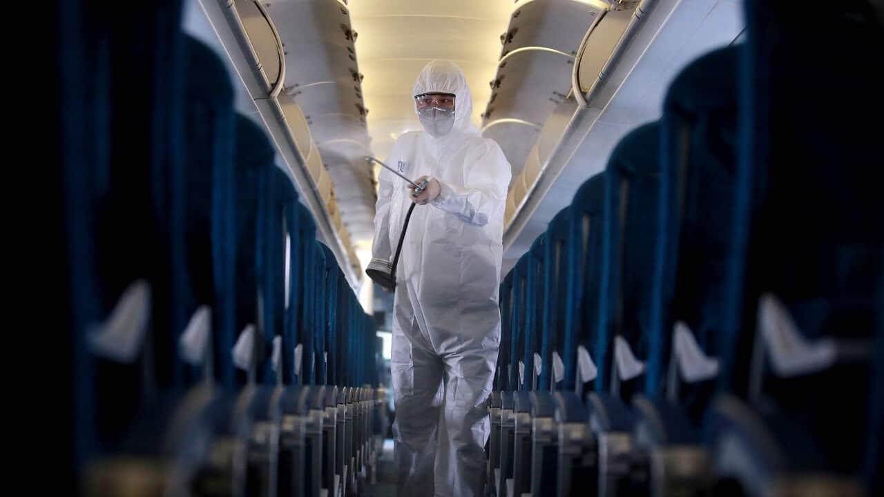 A worker sprays disinfectant as a precaution against coronavirus