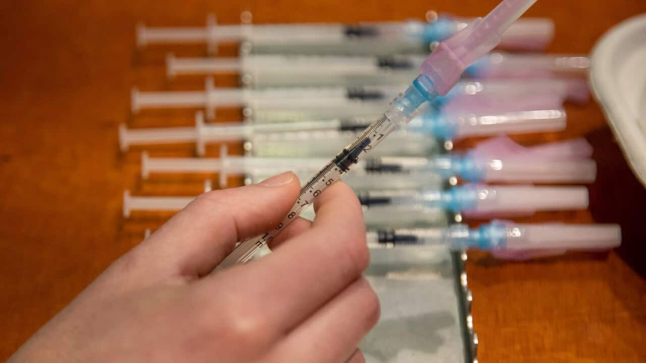 A health worker prepares to administer a Covid-19 vaccine