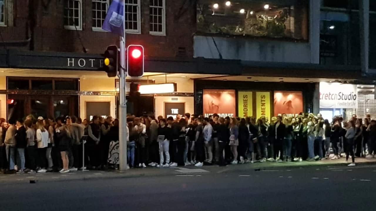 A huge crowd lines up to get into Sydney's Golden Sheaf pub on Wednesday night. 