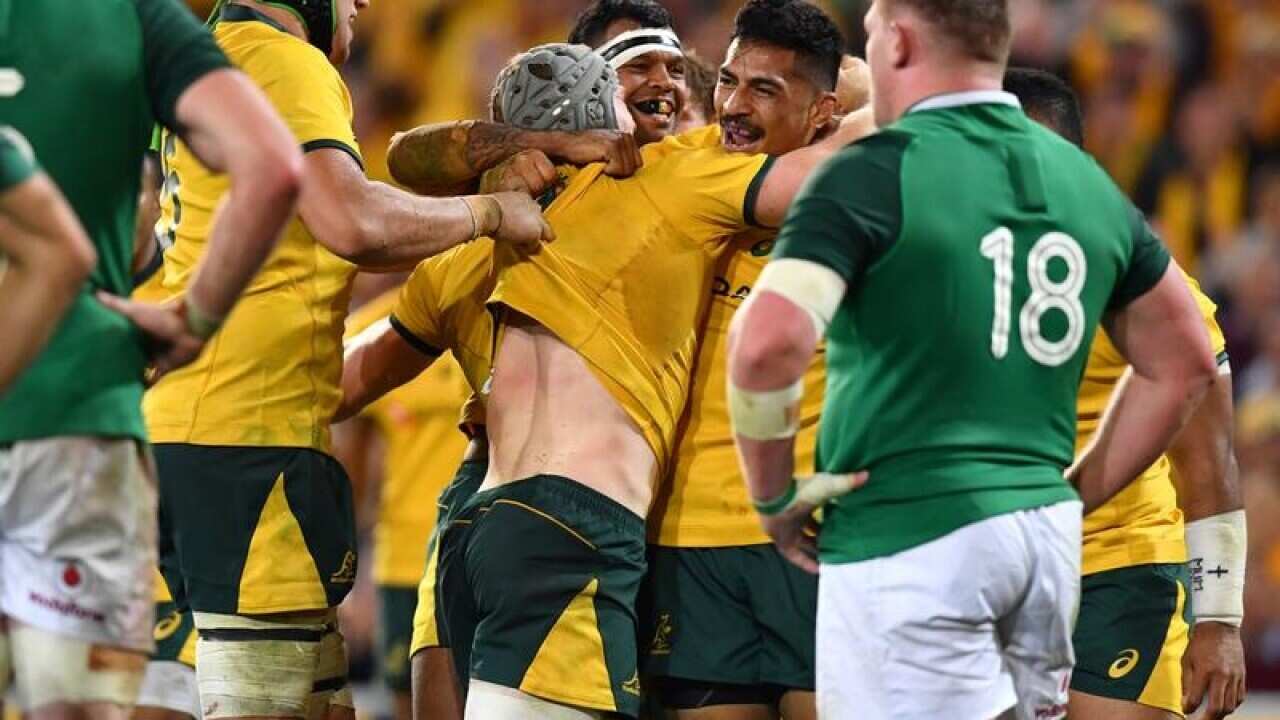 David Pocock of the Wallabies celebrates scoring a try with teammates.