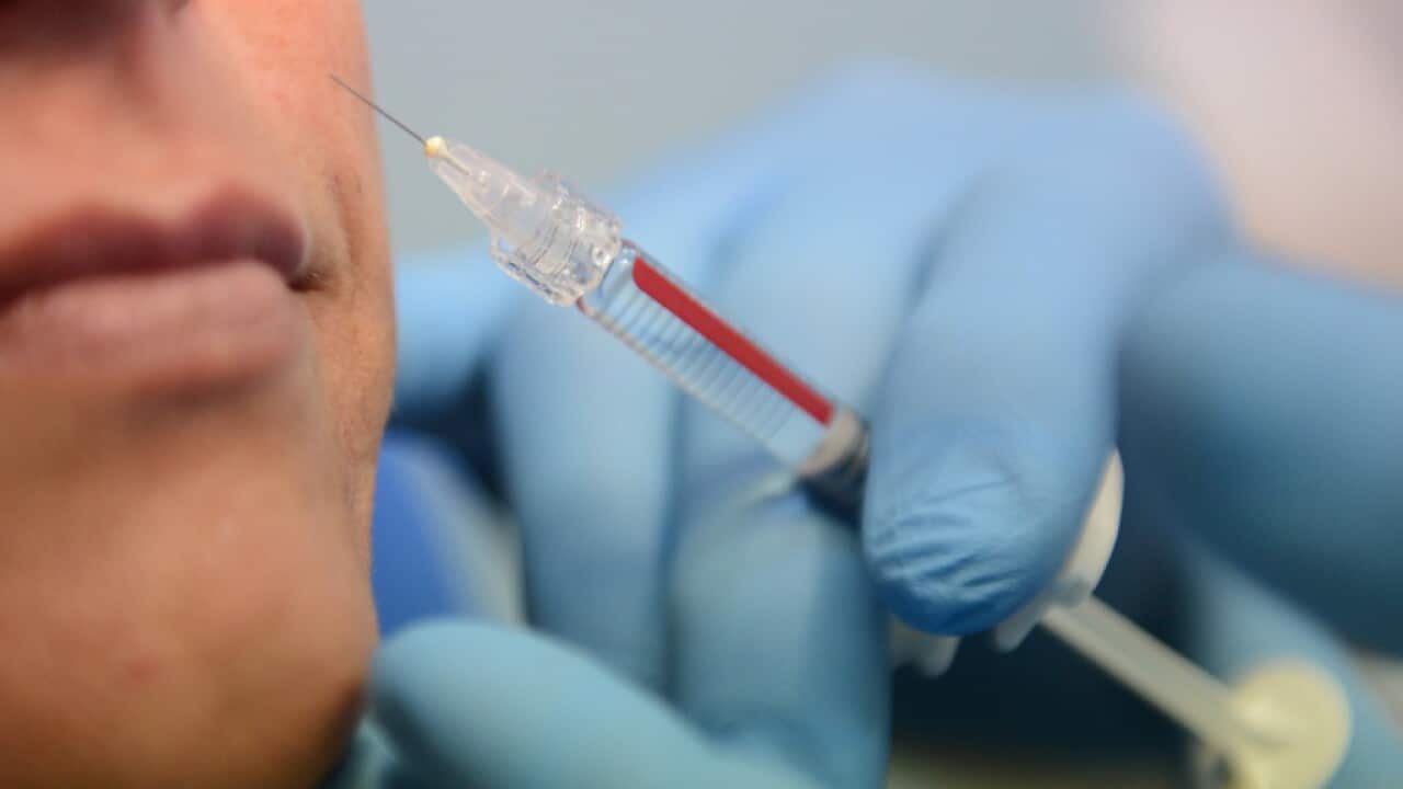 Dr. Peter Bakaric injects collagen into a patient at the Collagen Face Centre in Sydney, Thursday, April 12, 2012. (AAP Image/Dean Lewins)