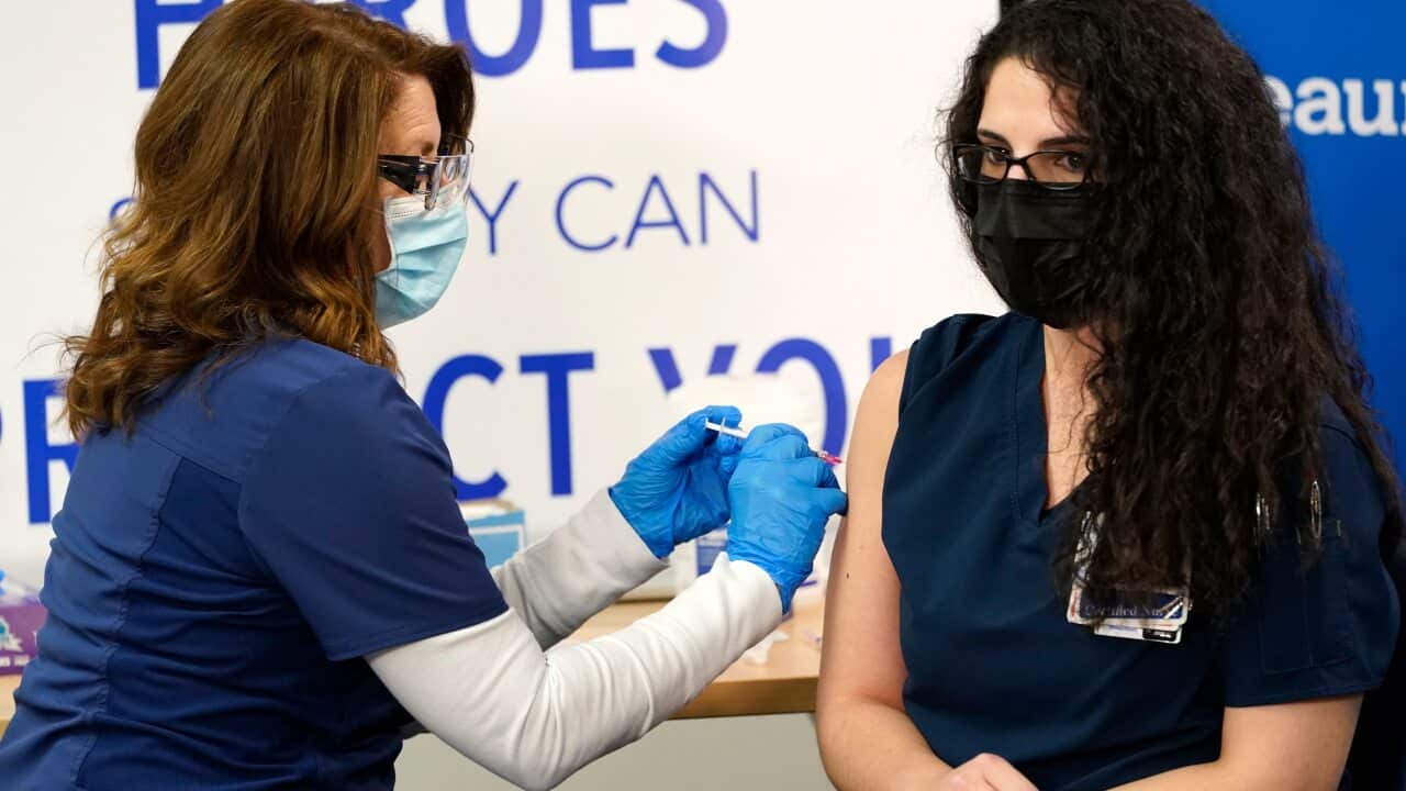 Paula Levesque administers a second Pfizer-BioNTech COVID-19 vaccine