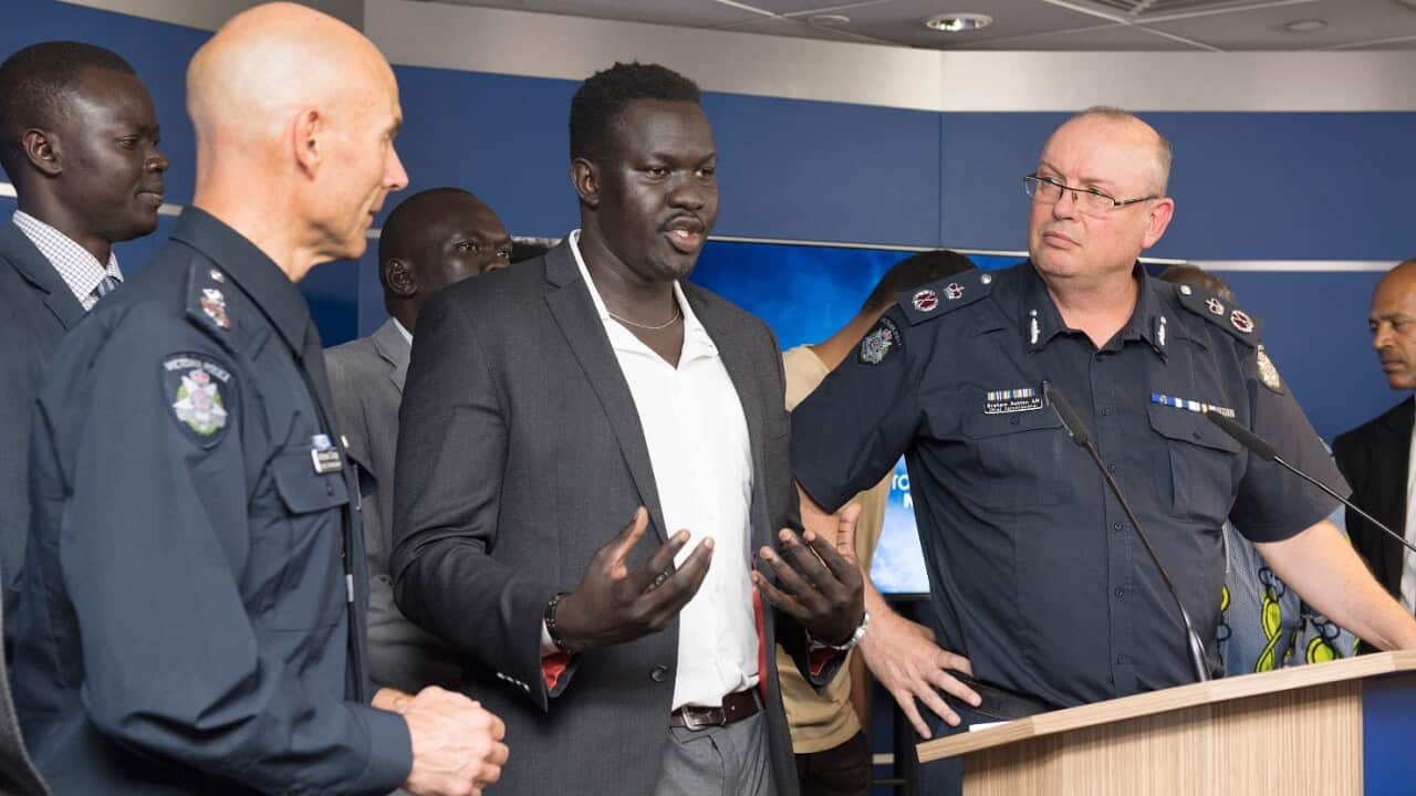 Victorian Deputy Commissioner Andrew Crisp (left) and Chief Police Commissioner Graham Ashton listen as African community leader John Kuot 