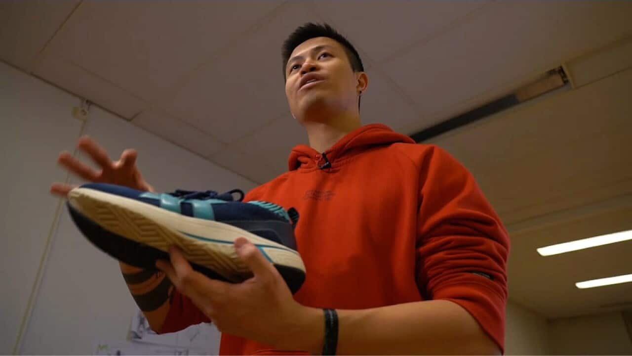 Jesse Tran with one of his sneakers made from coffee grounds (AP)