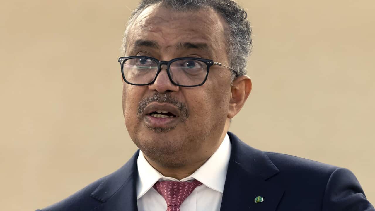 A man standing at a lectern speaking.