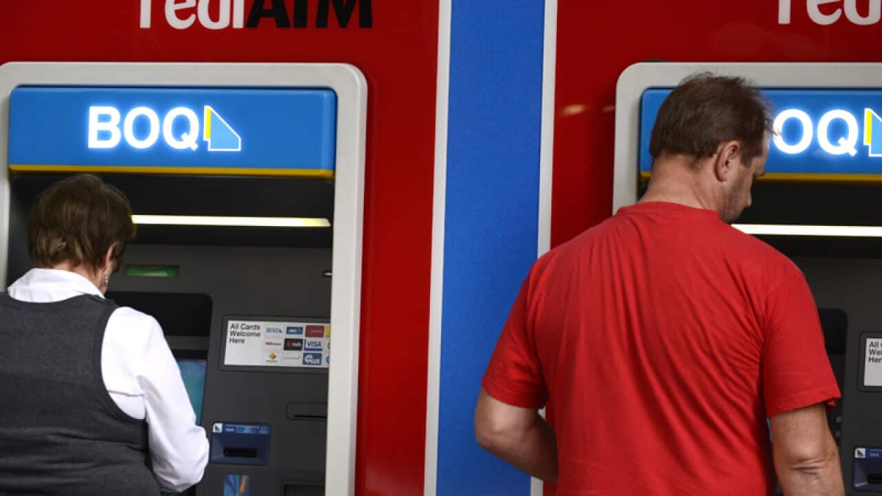 Customers at a Bank of Queensland ATM