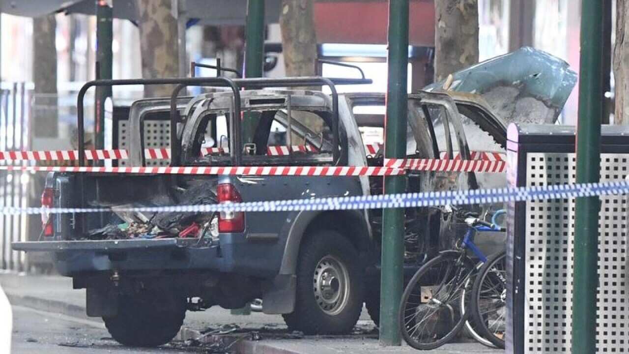 A burnt out vehicle is seen on Bourke Street in Melbourne.