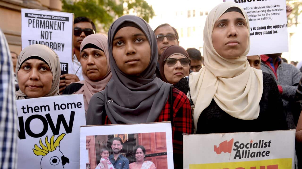 Demonstrators march through Sydney's CBD during a rally calling for refugee rights in Sydney.
