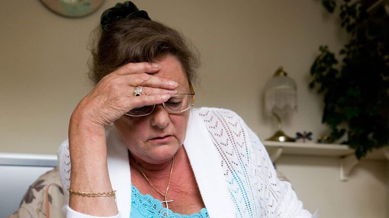 Stressed mature woman reads bills