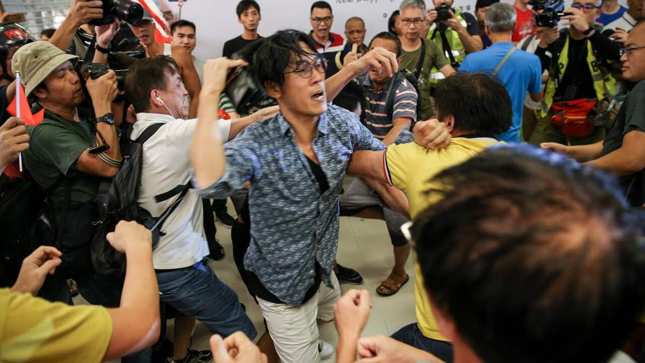 Anti-government protesters and pro-China supporters scuffle inside a shopping mall in Hong Kong.
