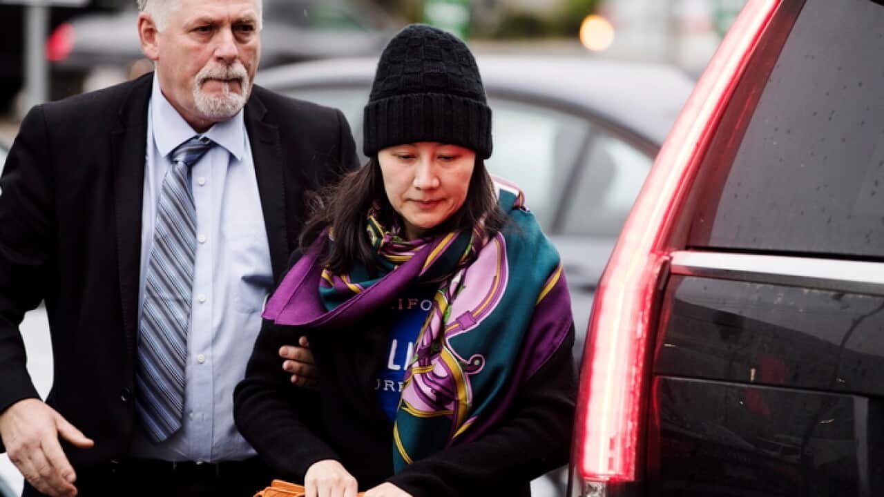 Huawei chief financial officer Meng Wanzhou with a security guard in Vancouver, Canada