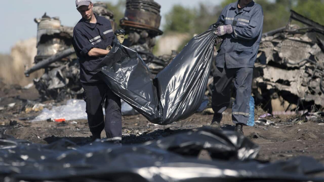 Ukrainian Emergency workers carry a victim's body in Ukraine