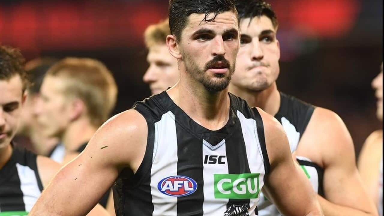 Scott Pendlebury of the Magpies (centre)