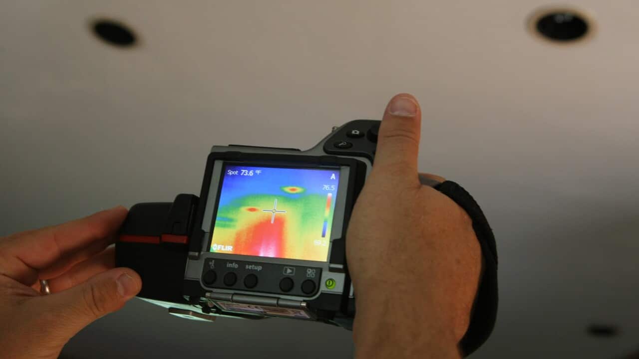 An infrared camera being used to check insulation in a room