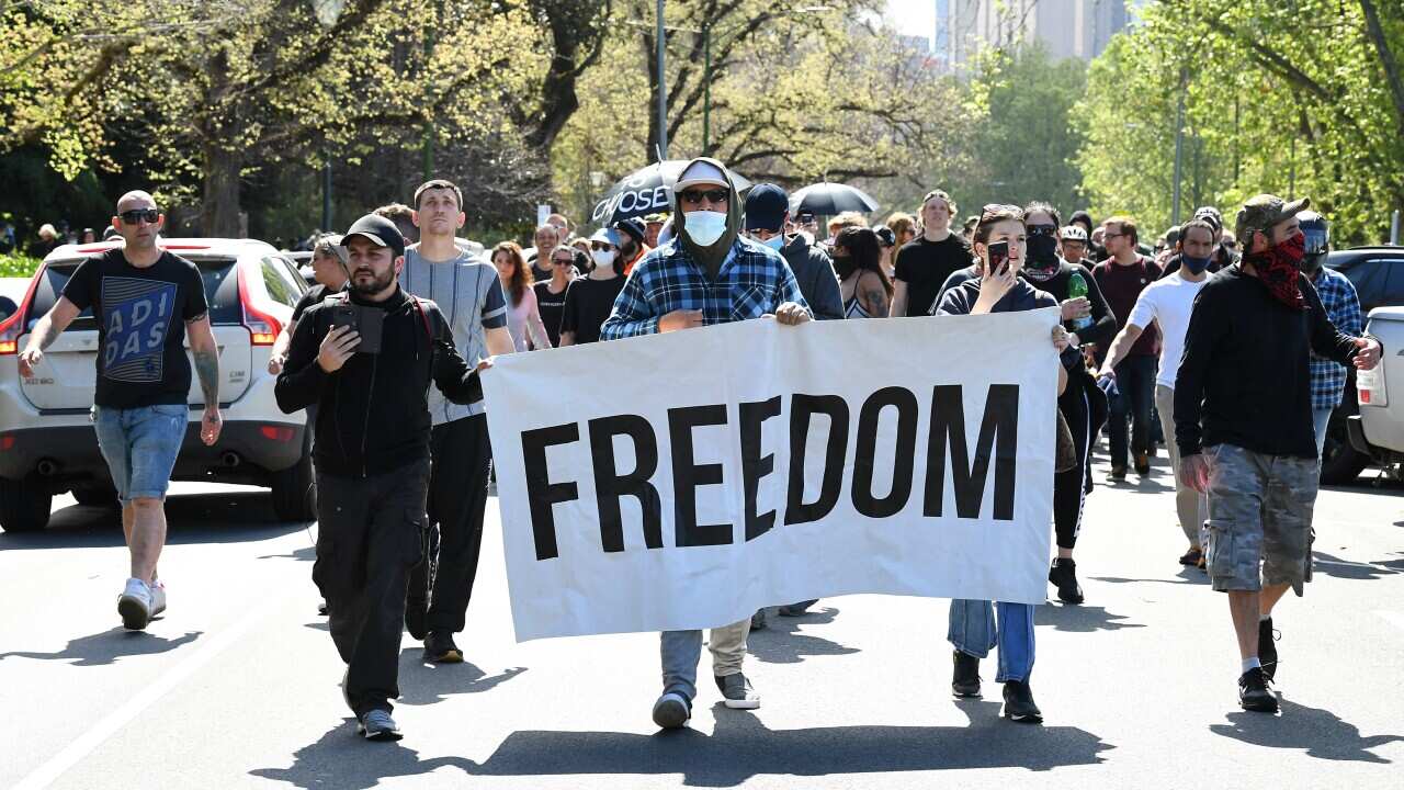 Protesters are seen during a protest in Melbourne, Saturday, October 2, 2021. (AAP Image/James Ross) NO ARCHIVING