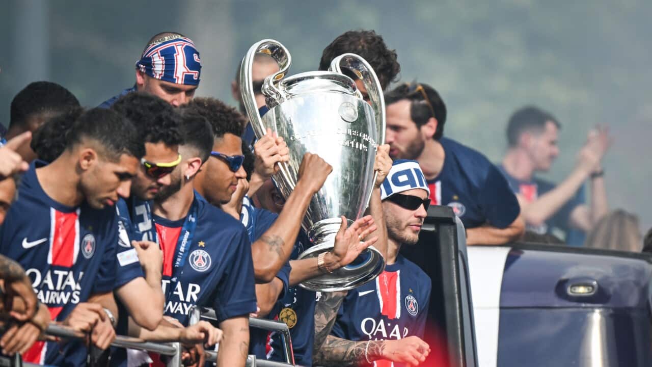 Supporters cheer the PSG in a parade in Paris - FA