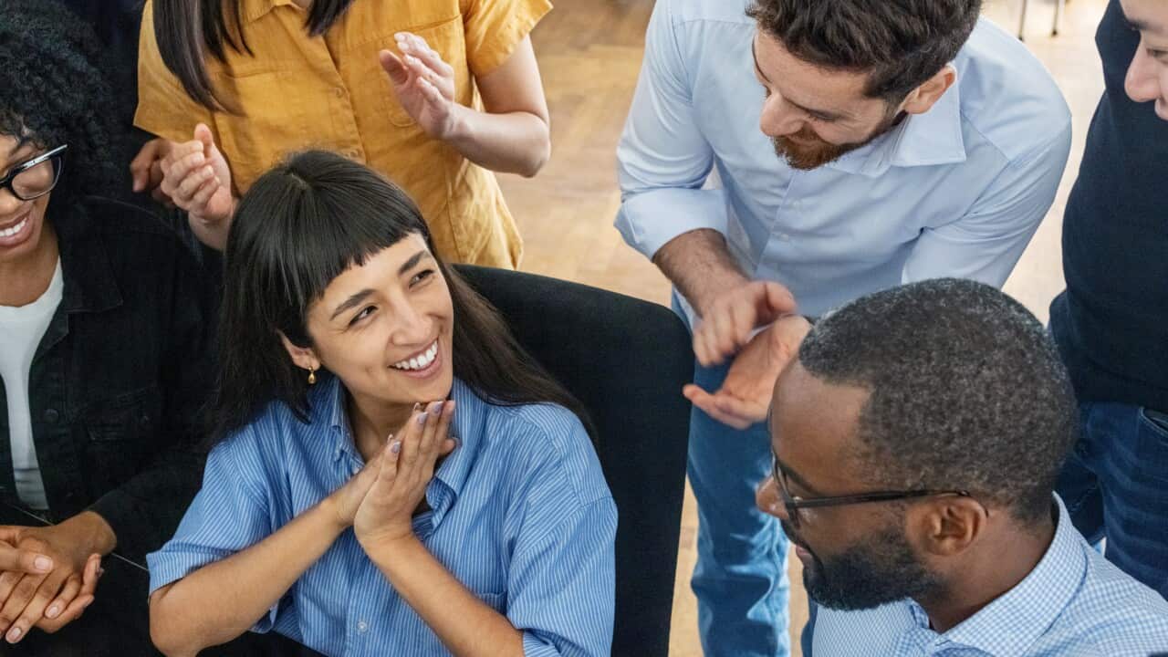 Startup team celebrating successful business deal announcement