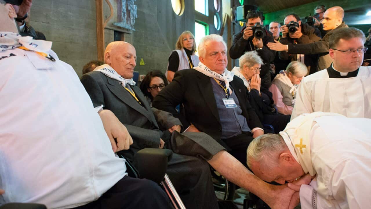 Pope Francis washes the feet of elderly and disabled people