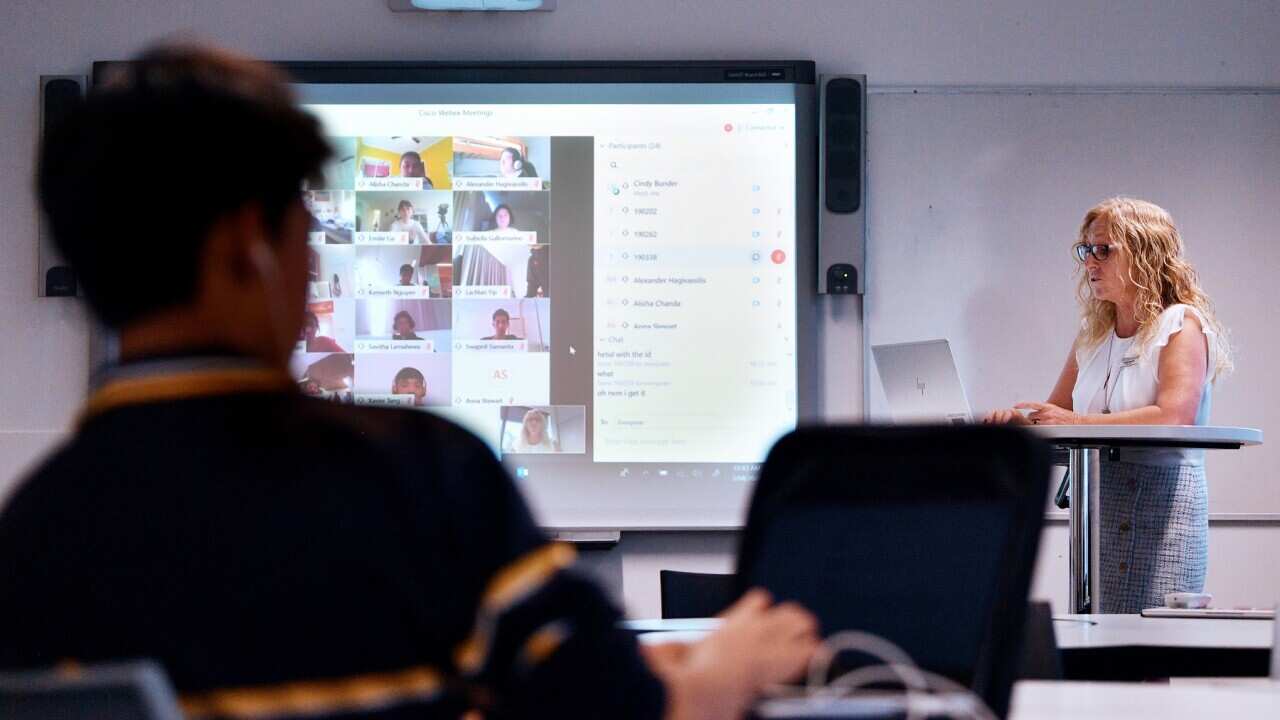 Teacher Cindy Bunder is seen demonstrating a virtual classroom at Glenunga High School in Adelaide, Friday, April 3, 2020. The school has introduced virtual classrooms. (AAP Image/David Mariuz) NO ARCHIVING