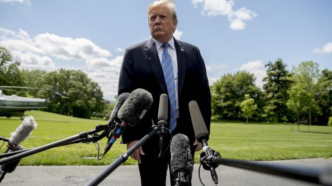 President Trump talks to reporters at the White House