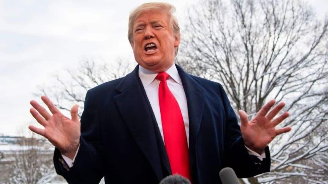 President Donald Trump speaks to the media as he departs the White House in Washington, DC, on January 14, 2019 en route to New Orleans, Louisiana to address the annual American Farm Bureau Federation convention.