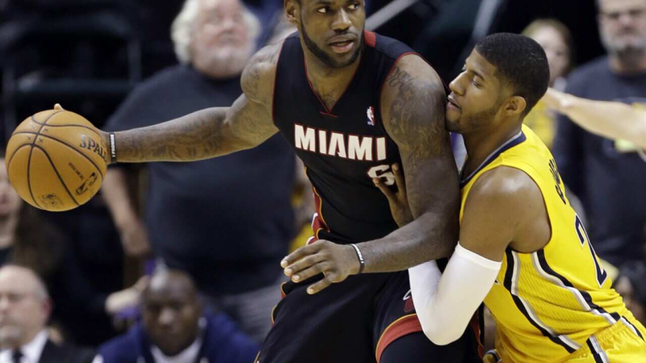 Miami Heat's LeBron James (L) and Indiana Pacers' Paul George