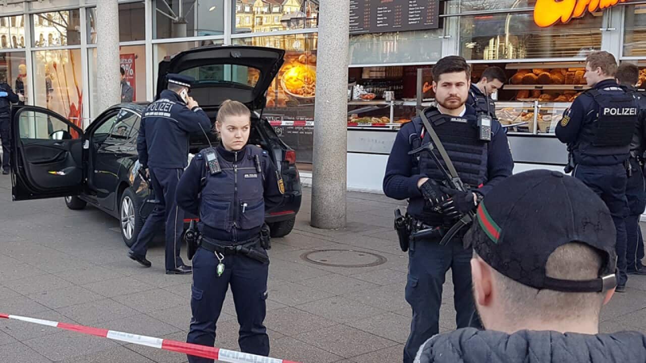 Police officers stand in front of a car in Heidelberg, Germany