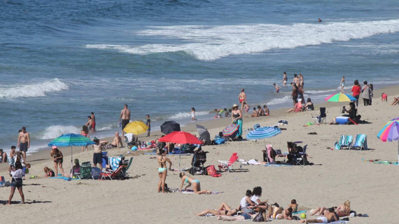 Swimmers and sunbathers gather at Redondo Beach, Calif.