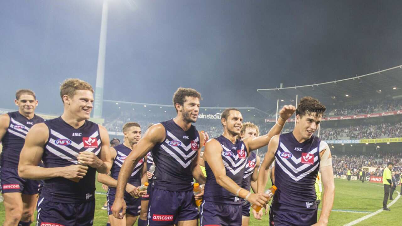 Alex Pearce of the Fremantle Dockers leads his team