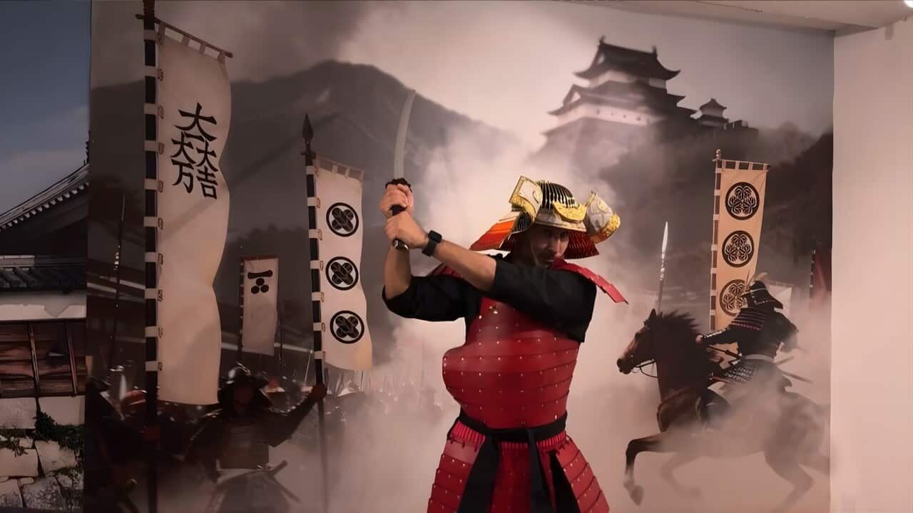 A tourist practises his Samurai moves (AP).jpg