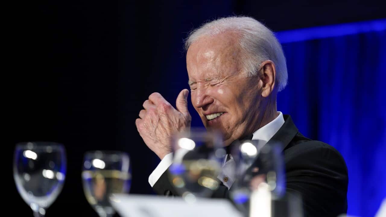 President Joe Biden laughs as he listens to Trevor Noah, host of Comedy Central's The Daily Show, speak at the annual White House correspondents' dinner.