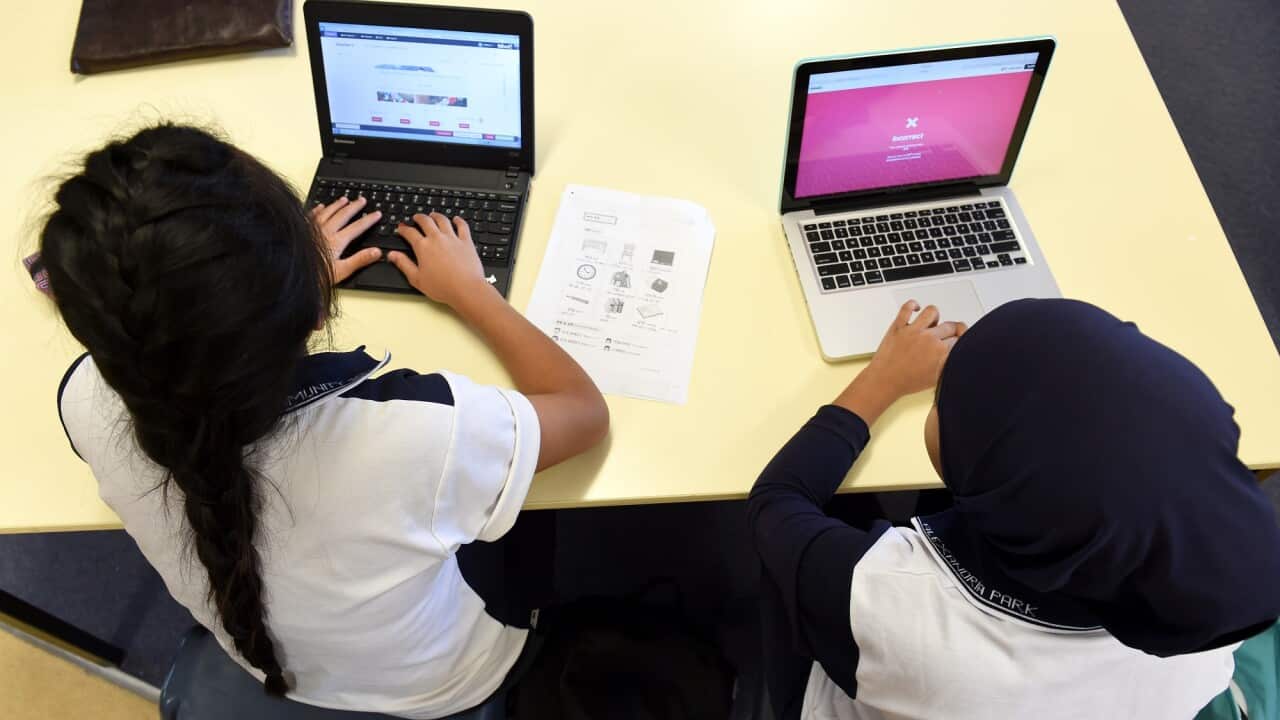 The use of artificial intelligence in classrooms as learning tool has it pros and cons, according to educators. Students at a Sydney school use laptops to finish their coursework (AAP) .