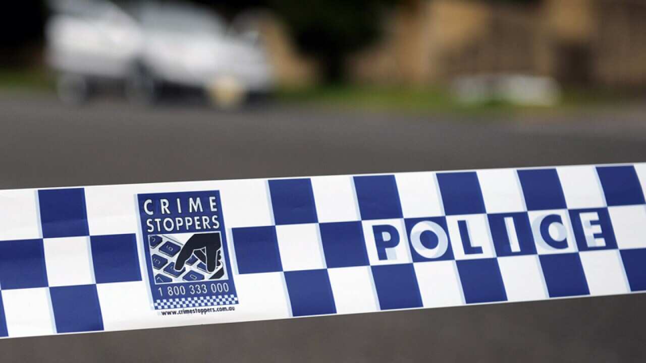 Police tape restricts access to a street