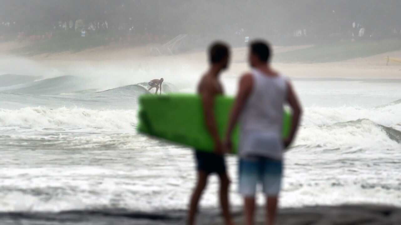 Surfers take advantage of big seas in Mooloolaba on the Sunshine Coast