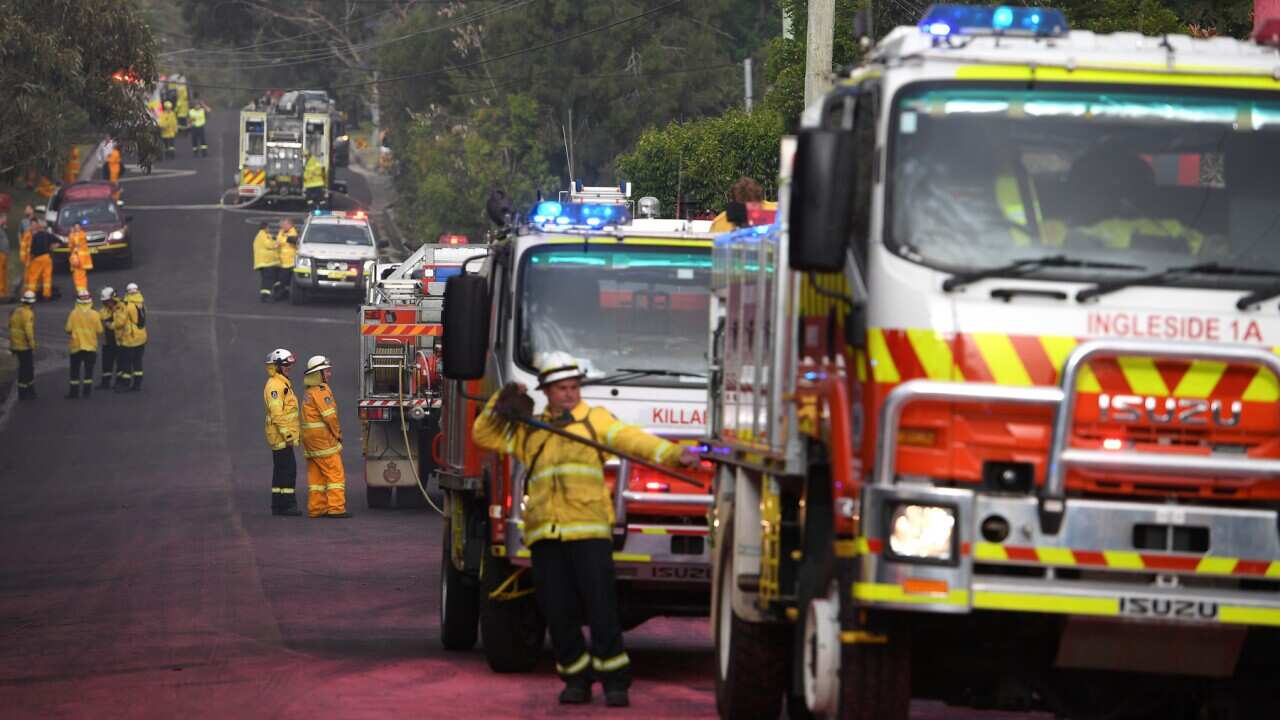 NSW Rural Fire Service crews protect properties on Canoon Rd, South Turramurra, north of Sydney, Tuesday, November 12, 2019.