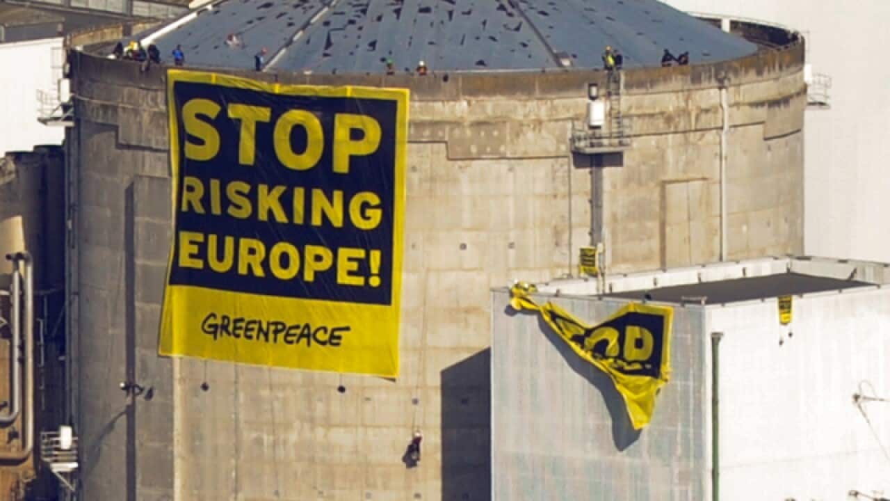 Greenpeace activists deploy a banner on a nuclear reactor in France
